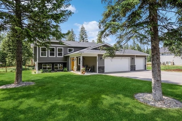 view of front of house with a front yard and a garage