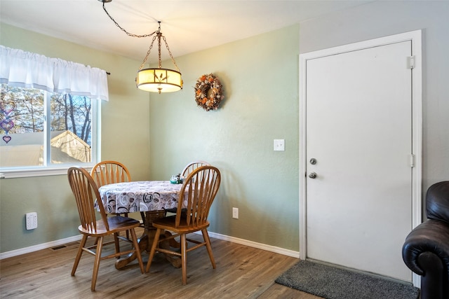 dining room with hardwood / wood-style flooring