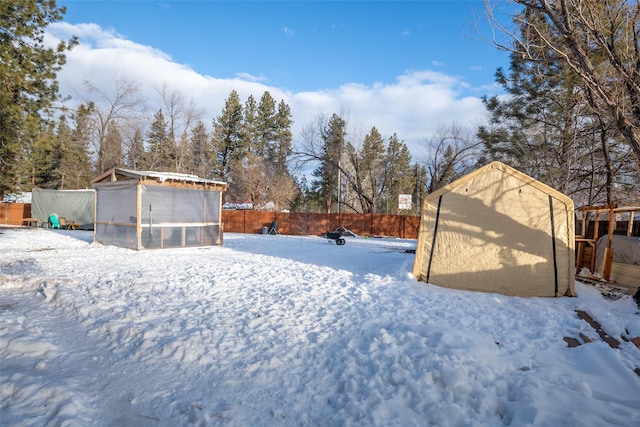 yard covered in snow with an outdoor structure