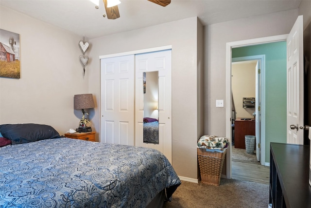 bedroom featuring ceiling fan, a closet, and dark colored carpet