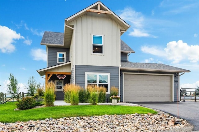 front of property with a front yard and a garage