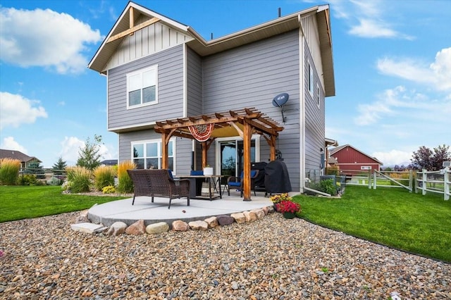 back of property featuring a patio area, a lawn, and a pergola