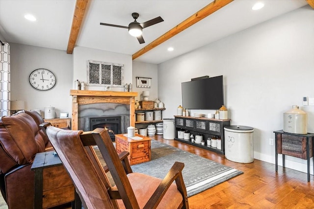 living room with ceiling fan, beamed ceiling, and hardwood / wood-style flooring