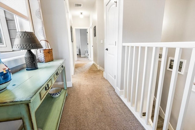 hallway with light colored carpet