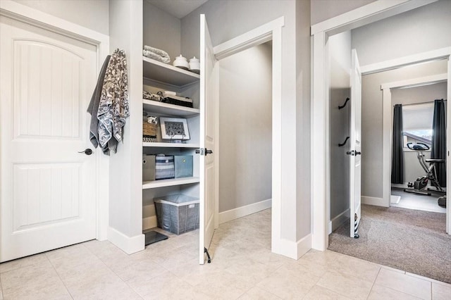 spacious closet featuring light carpet