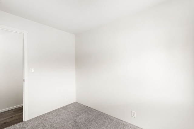 empty room featuring dark carpet