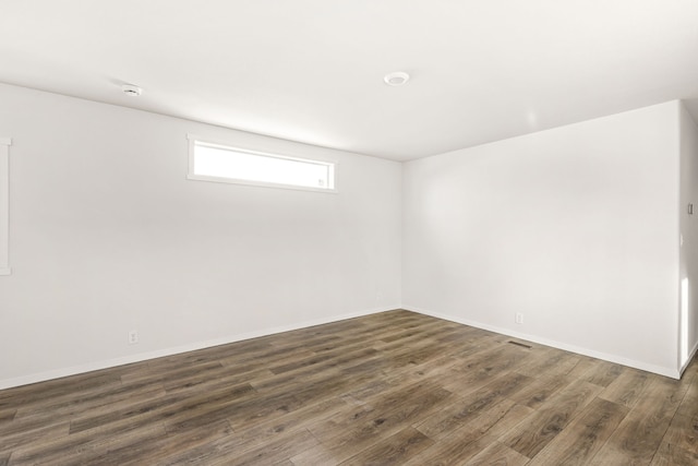 unfurnished room featuring dark wood-type flooring