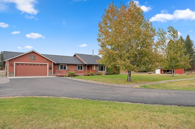 single story home with a garage and a front lawn