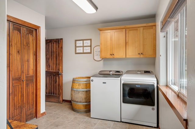 laundry area featuring cabinets and washing machine and dryer