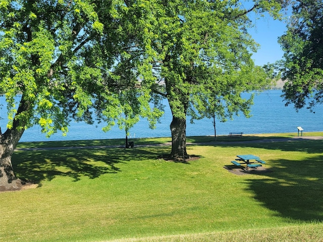 view of property's community featuring a water view and a yard