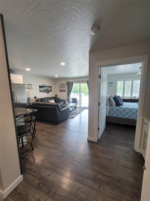 living room featuring a textured ceiling and dark hardwood / wood-style flooring