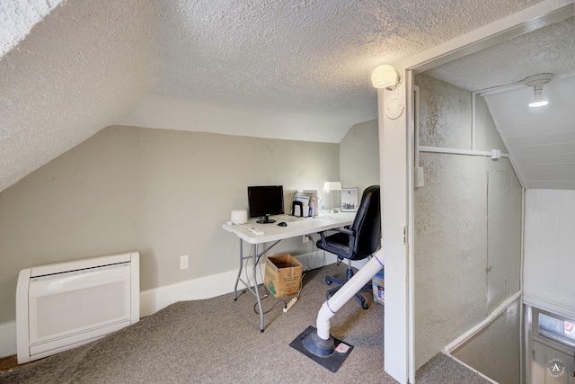 carpeted office space with vaulted ceiling and a textured ceiling