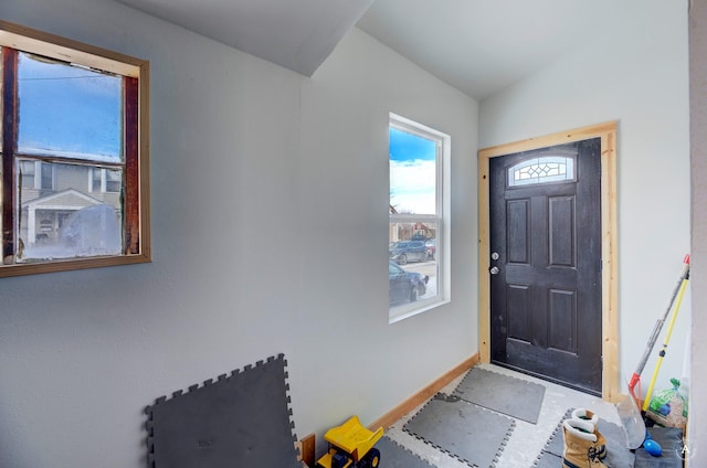 foyer entrance featuring vaulted ceiling