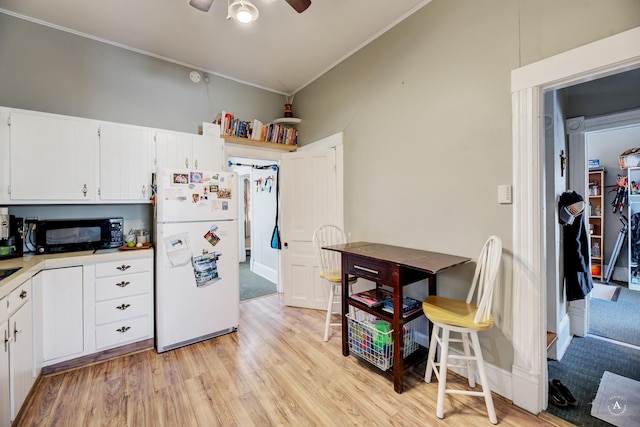 kitchen featuring white fridge, ceiling fan, white cabinetry, and light wood-type flooring