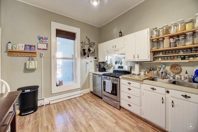 kitchen with white cabinetry, stainless steel appliances, sink, ornamental molding, and light wood-type flooring