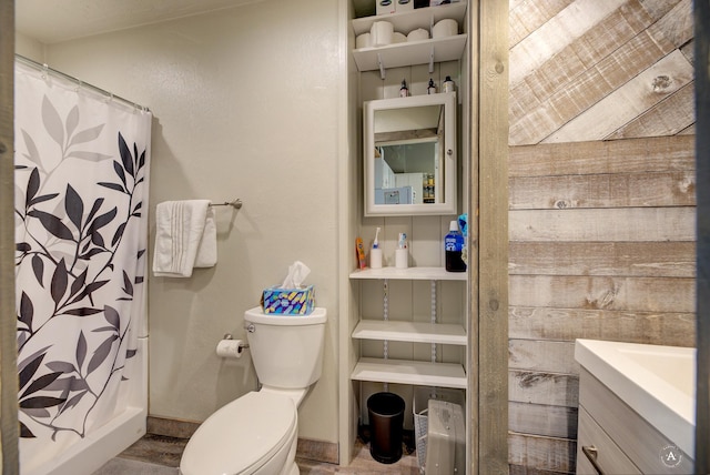 bathroom featuring toilet, vanity, and a shower with curtain