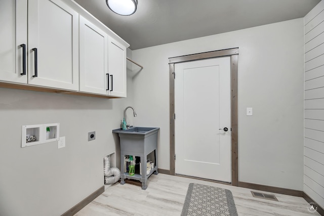 laundry area featuring hookup for a washing machine, light wood-style flooring, visible vents, cabinet space, and electric dryer hookup