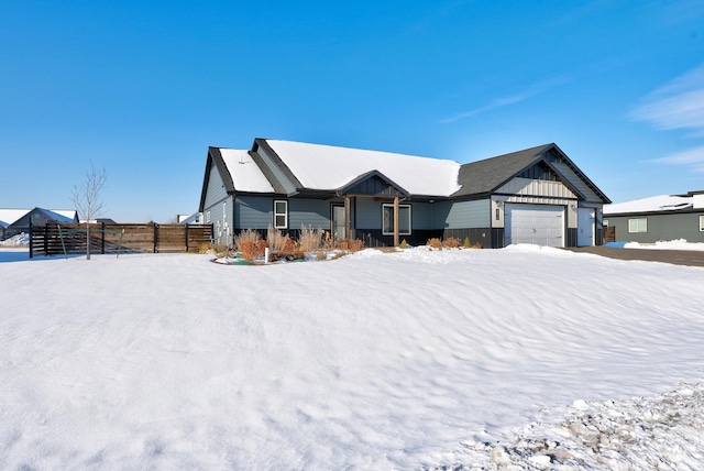 view of front of property featuring board and batten siding and fence