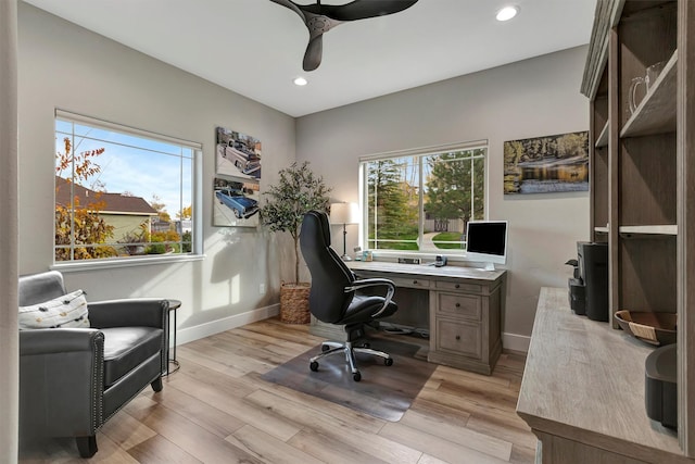 office space featuring ceiling fan and light hardwood / wood-style floors