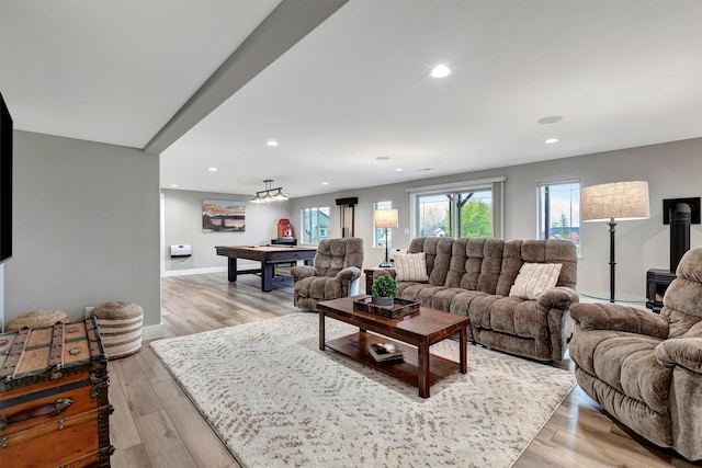 living room featuring billiards and light hardwood / wood-style flooring