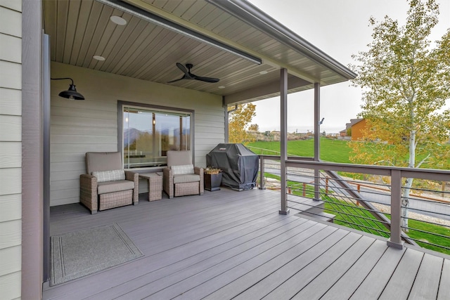 wooden terrace featuring ceiling fan and grilling area