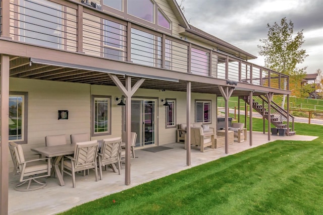 rear view of house with a patio area, outdoor lounge area, a yard, and a deck