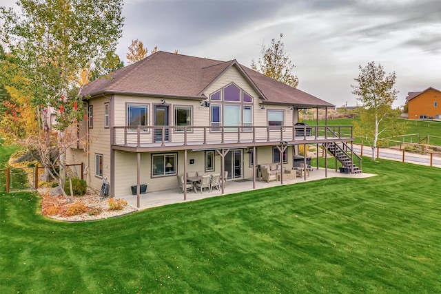 back of property featuring a patio area, a wooden deck, and a yard