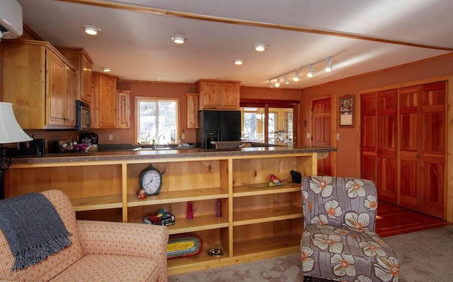 kitchen with recessed lighting, a wall mounted air conditioner, dark countertops, black appliances, and a peninsula