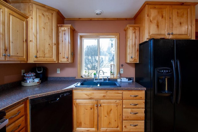 kitchen featuring dark countertops, ornamental molding, a sink, and black appliances