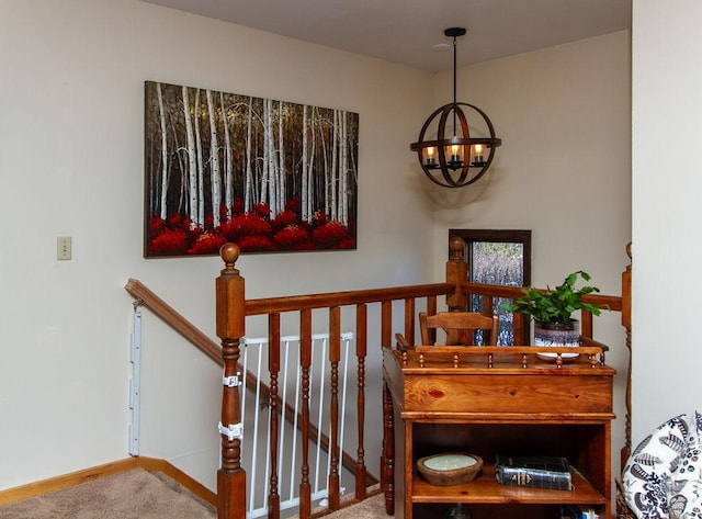 staircase with carpet, an inviting chandelier, and baseboards