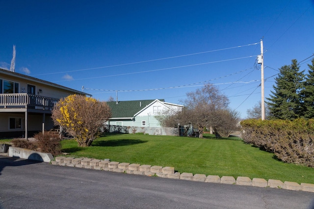view of yard featuring fence and a wooden deck