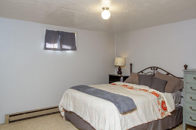 bedroom featuring a baseboard heating unit and carpet flooring