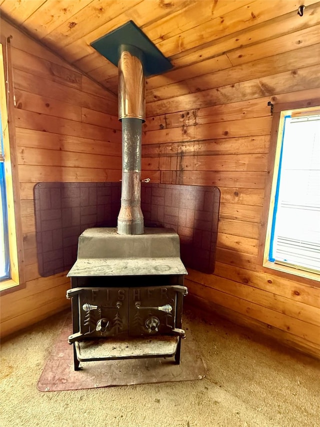 interior details with carpet floors, wood ceiling, and wooden walls