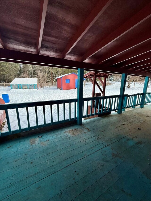 yard covered in snow featuring a storage shed