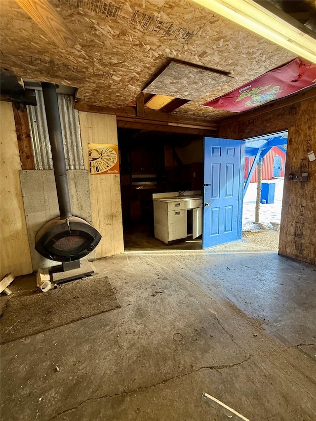 unfurnished living room with a wood stove