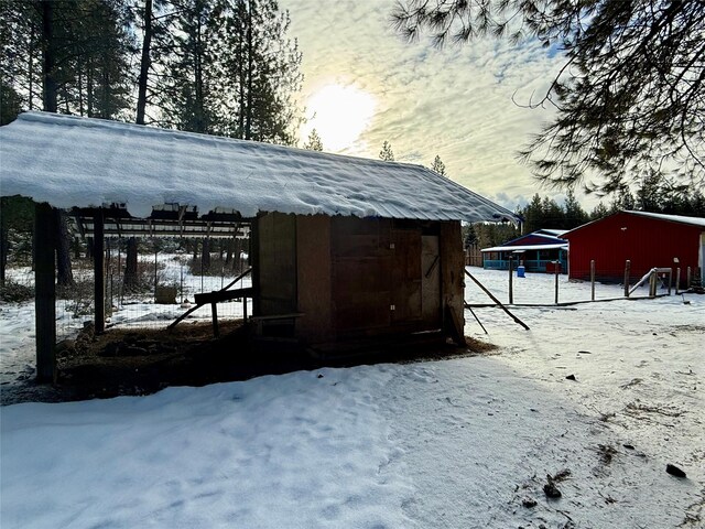 yard covered in snow with an outdoor structure