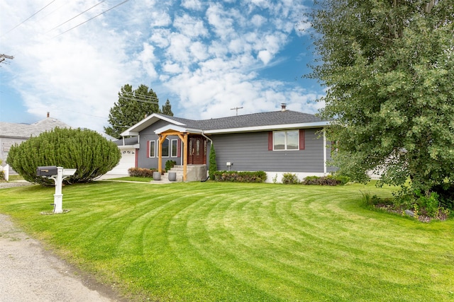 ranch-style home featuring a garage and a front yard