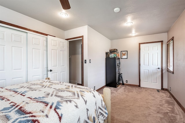 bedroom with ceiling fan and light carpet