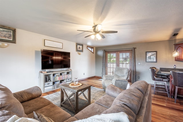 living room featuring ceiling fan and light hardwood / wood-style flooring