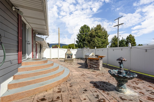 view of patio / terrace with an outdoor stone fireplace