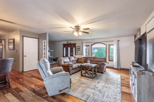 living room with ceiling fan and hardwood / wood-style floors