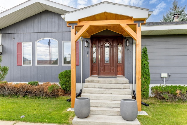 property entrance with a yard