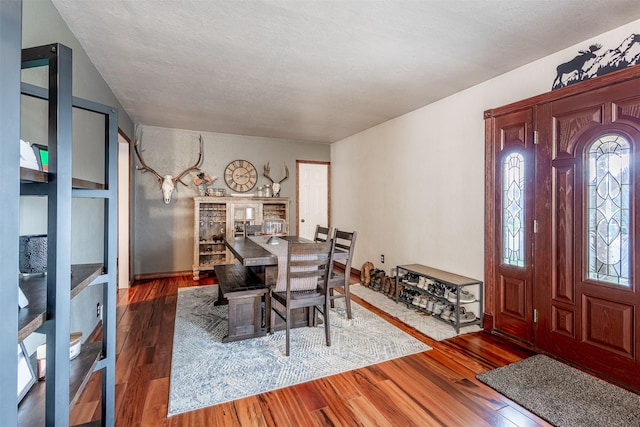 dining space with dark hardwood / wood-style flooring