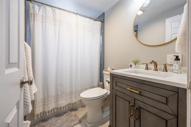 bathroom with toilet, tile patterned floors, and vanity