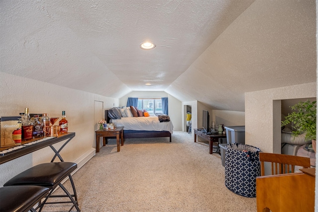 carpeted bedroom featuring a textured ceiling and lofted ceiling