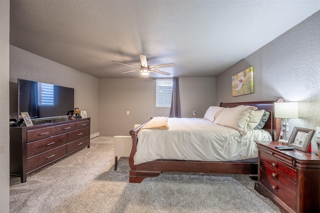 bedroom with ceiling fan, light colored carpet, a textured ceiling, and baseboard heating