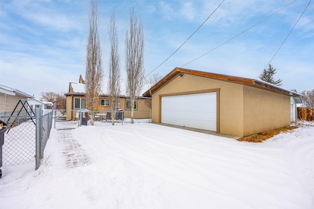 exterior space featuring a garage and an outdoor structure