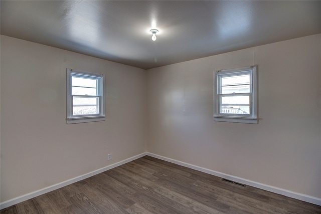 spare room with dark hardwood / wood-style flooring