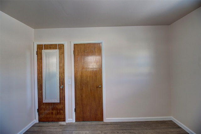 unfurnished bedroom featuring dark hardwood / wood-style floors