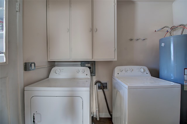 laundry room featuring washing machine and dryer, water heater, and cabinets